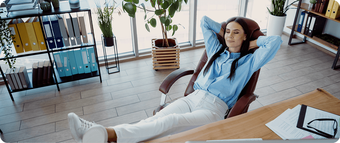 Relaxed businesswoman enjoying productivity after successful automation